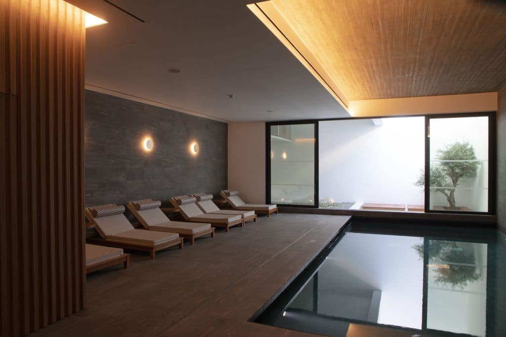 Althaea Spa relaxation lounge with wooden sun beds and ambient wall lighting